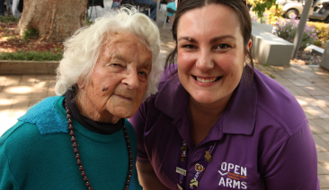 Two women smile for a photo