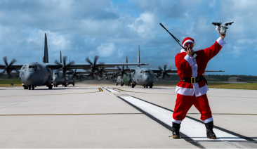 Santa on a runway with planes behind