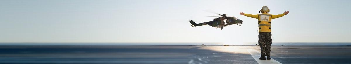 person guiding helicopter to land