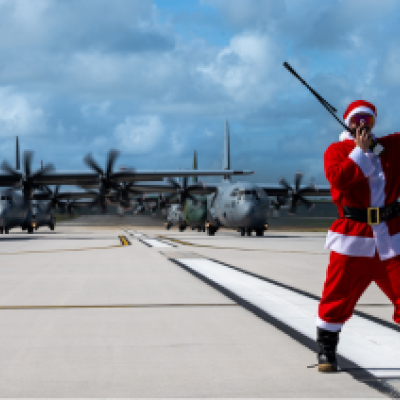 Santa on a runway with planes behind